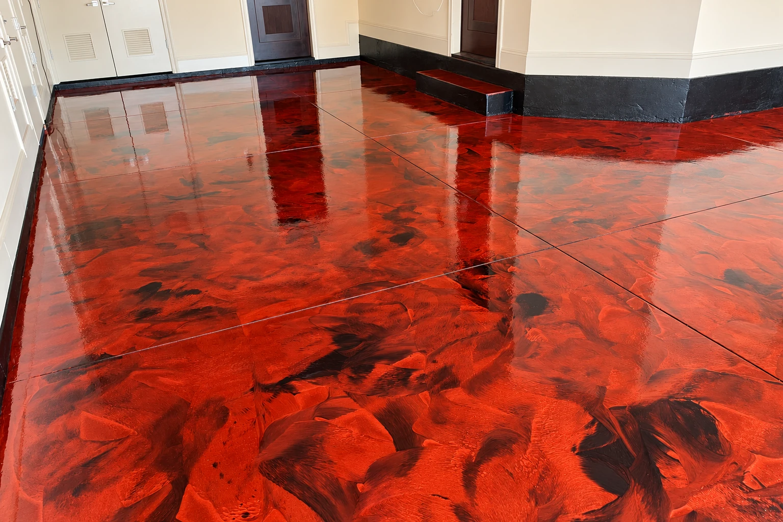 Glossy metallic epoxy floor with swirling red, orange, and black patterns in a bright interior.